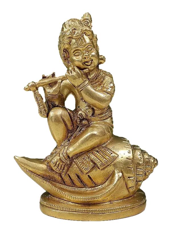 Baby Krishna Seated on Conch Playing the Flute In Brass